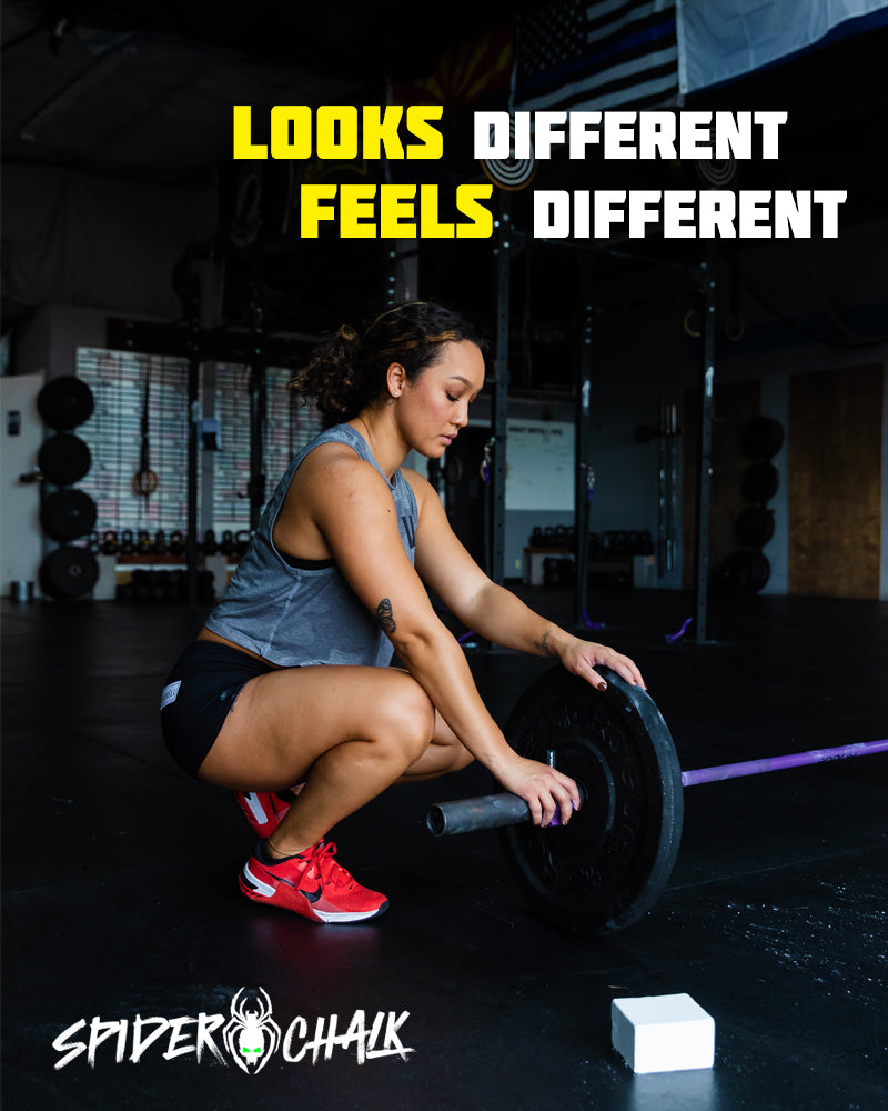 girl lifting a barbell with block of gym chalk on the ground