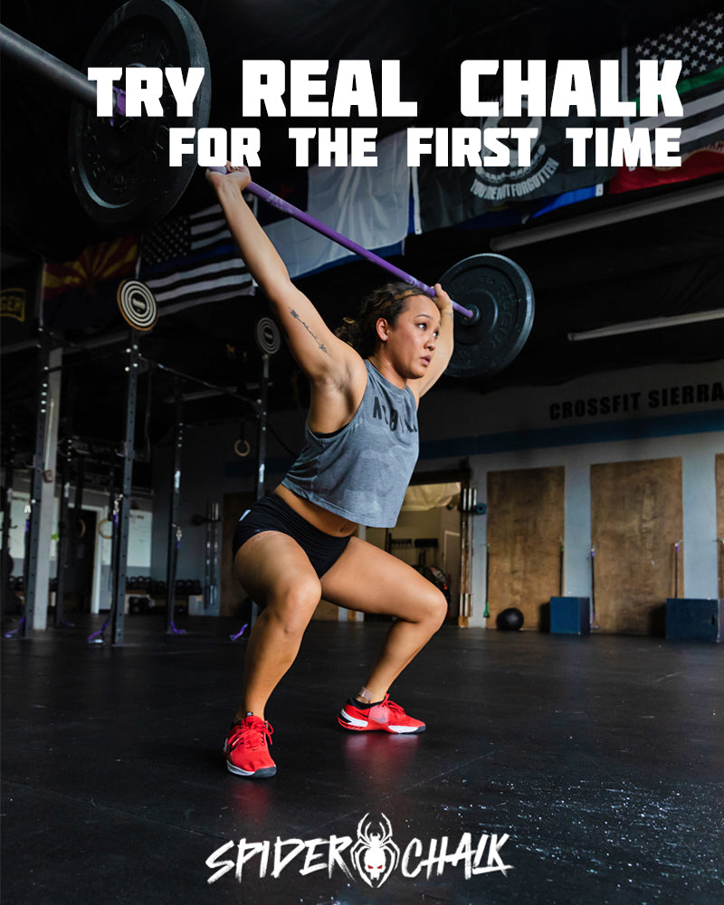 female lifter overhead squatting a barbell for weightlifting